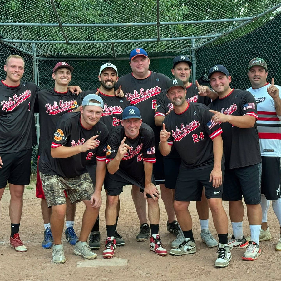 Red's Garage Port Chester softball team celebrating a championship in custom black and red 7Bros jerseys