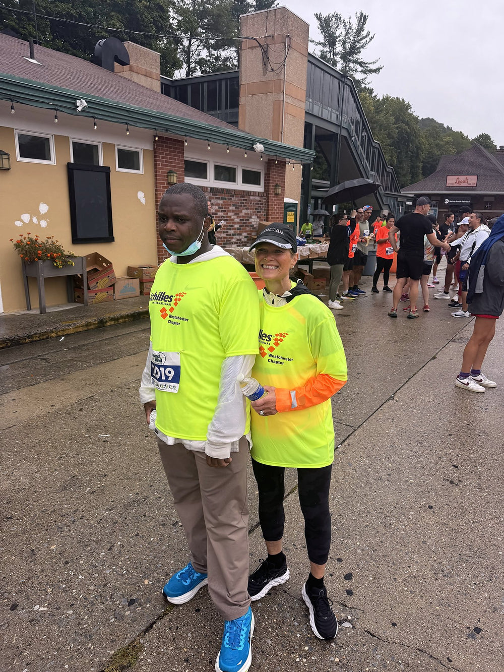 Two Achilles International Westchester Chapter athletes in custom neon yellow 7Bros race shirts
